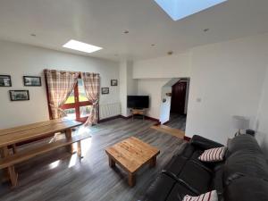 a living room with a couch and a table at Merrick Cottage in Bargrennan