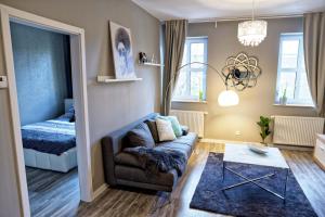 a living room with a couch and a bed at BanApart Apartments in Zgorzelec