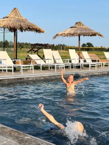 un niño en el agua en una piscina en STF Hostel Ihre Gård, en Ire