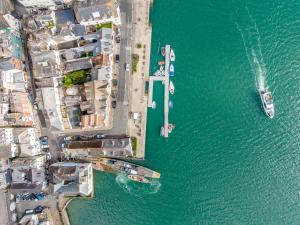 an overhead view of a dock with boats in the water at Waterfront House in Dartmouth