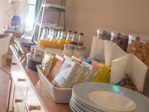 a counter with plates and other food items on it at Waterfront House in Dartmouth