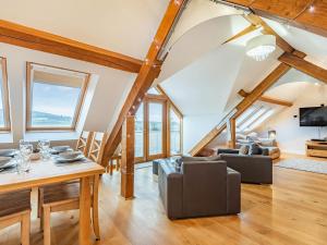 a living room with a table and a couch at The Barn At Whitefields in Walcot