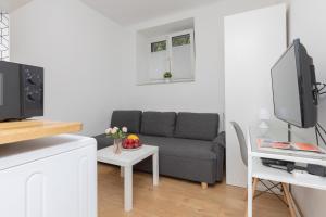 a living room with a couch and a table at Micro Apartment near Fort Mokotów in Warsaw