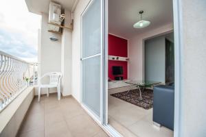 a living room with a sliding glass door and a table at The Waves Apartment Marsaxlokk in Marsaxlokk
