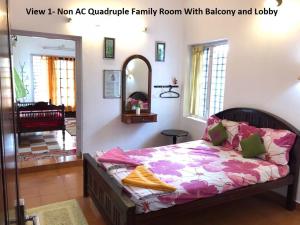 a bedroom with a bed in a room with a mirror at Sithara Homestay Fort Cochin in Cochin
