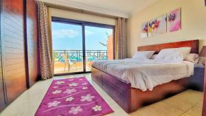 a bedroom with a bed and a large window at Prime Home The View Hurghada in Hurghada