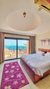 a bedroom with a bed and a view of the ocean at Prime Home The View Hurghada in Hurghada