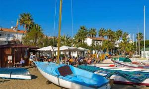 a group of boats sitting on the beach with people at CT 138 - La Cala Boulevard - Apartement I in La Cala de Mijas