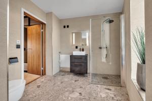 a bathroom with a shower and a toilet and a sink at Penthouse in Downtown Tromsø NEW in Tromsø +35 photos