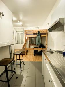 a kitchen with a loft with a table and chairs at Bienvenue dans le centre ville d’Amiens in Amiens