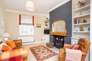 a living room with two chairs and a fireplace at Pass the Keys Quaint 2 Bed within City Walls in York