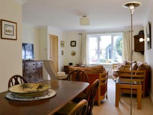 a kitchen and dining room with a table and chairs at Meadowcroft Cottage in Bowness-on-Windermere