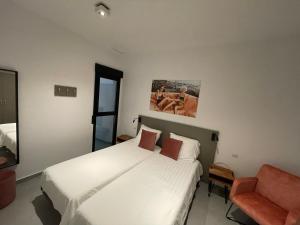 Łóżko lub łóżka w pokoju w obiekcie Casa 34