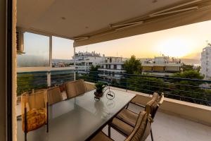 a table and chairs on a balcony with a view at Alex house in Varkiza