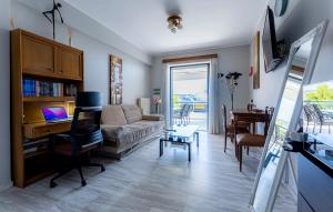 a living room with a couch and a desk at Alex house in Varkiza