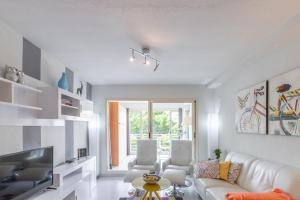 a living room with a white couch and a tv at Apartment Zeus in Calpe