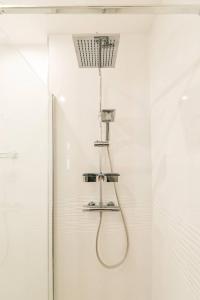 a shower with a shower head in a bathroom at 56-chabot-charny in Dijon