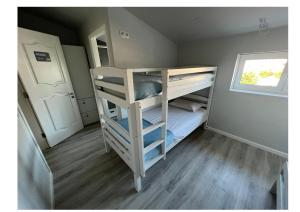 a bunk bed room with two bunk beds and a window at WE ARE HOSTEL in Póvoa de Varzim