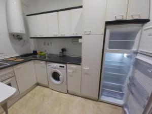 a kitchen with a refrigerator and a washing machine at Apartamento Ideal Retiro - Centro de Madrid in Madrid
