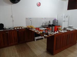 a kitchen with a counter with food on it at Hostel Pousada do Tapajós in Alter do Chao