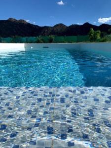 a pool of blue water with a tile floor at Cuesta de san miguel in Chilecito
