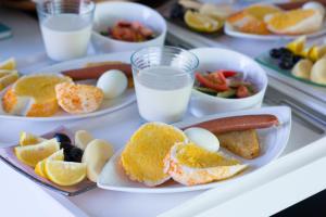 a tray of food with plates of breakfast foods and milk at Han-Shian Boutique B&B in Dongshan