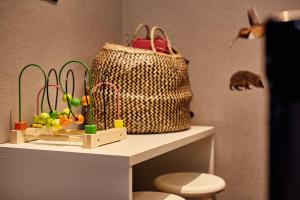 a table with a bag and toys on a shelf at Van der Valk Hotel Nijmegen-Lent in Nijmegen