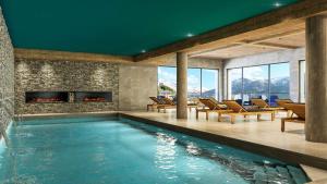a swimming pool with a fireplace in a house at HIGALIK HOTEL in Les Menuires