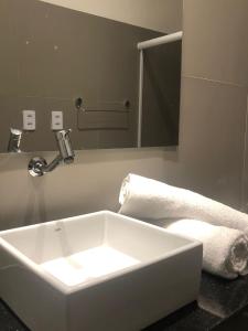 a bathroom with a white sink and a mirror at Pousada Portas da Amazônia in São Luís