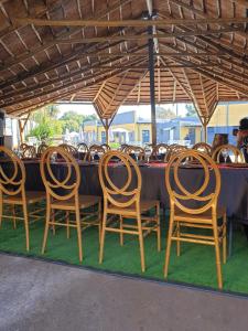 a group of chairs sitting at a table under an umbrella at Platinum Guest lodge Germiston in Germiston
