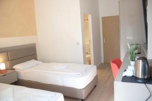 Postel nebo postele na pokoji v ubytování Isar City Hotel