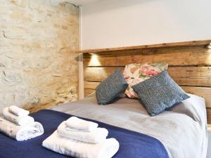 a bedroom with a bed with towels on it at Writers Cottage - Uk33475 in Nenthead