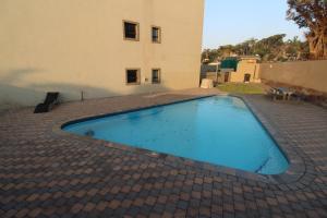 a swimming pool in front of a building at Saints View Resort Unit 1 in Uvongo Beach