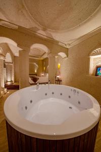 a large bathroom with a large tub in a room at FARMER CAVE HOUSE in Ürgüp