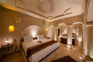 a bedroom with a large bed in a room at FARMER CAVE HOUSE in Urgup