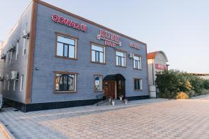 a blue building with a sign on the side of it at RUSH BUTIK in Atyraū