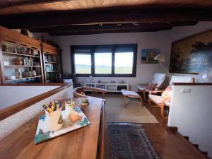 a kitchen and living room with a table with pencils on it at Cal Manso in Arnés