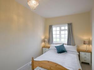 a bedroom with a bed and a window at The Retreat in Whitchurch