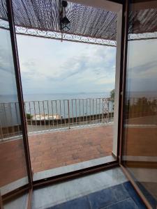 uma vista para o oceano a partir de uma janela de vidro em La Casa di Nunzia B&B em Positano