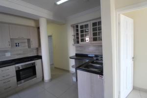 a kitchen with a sink and a stove at Saints View Resort Unit 3 in Uvongo Beach