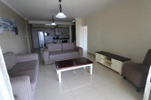 a living room with a couch and a coffee table at Saints View Resort Unit 3 in Uvongo Beach