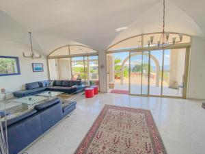 a large living room with blue couches and a rug at Villa St Maxime in Saint Paul de Vence