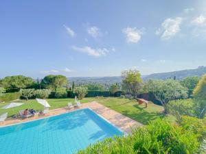 a swimming pool with a view of a garden at Villa Saint Maxime in Saint Paul de Vence +57 photos