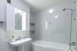 a white bathroom with a sink and a shower at Apartment Zeus in Calpe +13 photos