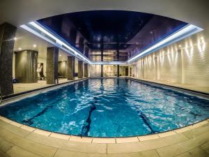 a large swimming pool in a building at Holiday Inn London Kensington High St., an IHG Hotel in London