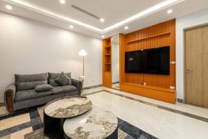 a living room with a couch and a tv at Lakeside House 3 in Hanoi