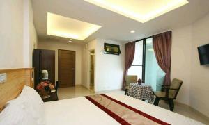 a hotel room with a bed and a table and a chair at Ziteng Hua Homestay in Hualien City