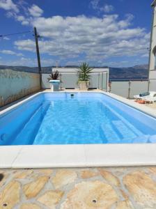 a large blue swimming pool in a house at Apartments Sollis in Trogir