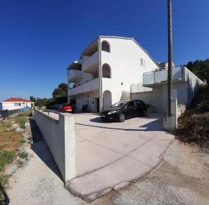 a black car parked in front of a building at Apartments Sollis in Trogir