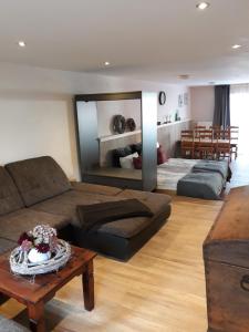 a living room with a couch and a table at Hof Timmermann - Alte Werkstatt in Ottenstein